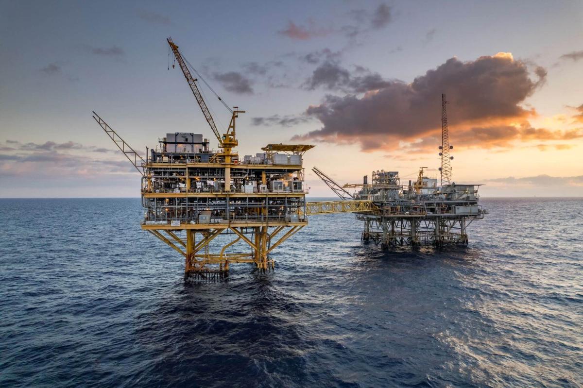 Two offshore platforms in the Gulf of Mexico at sunset